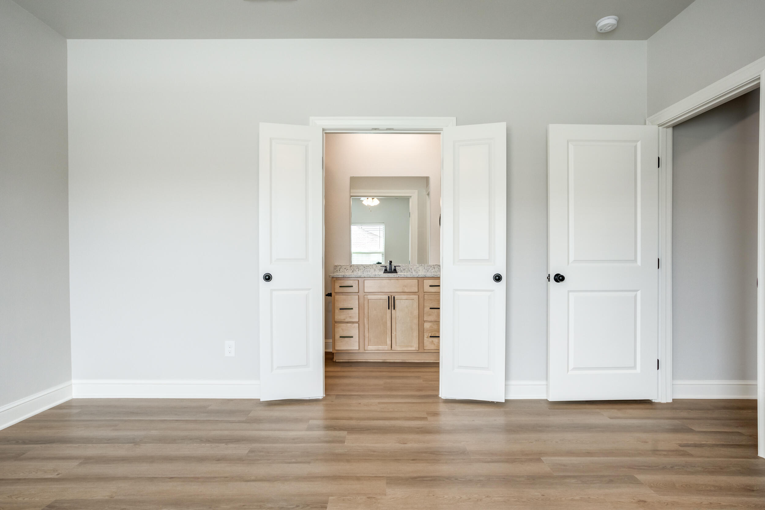 2534 137th Street Lubbock, TX 79423 - Photo 35 of 46 a view of a kitchen from the hallway with wooden floor