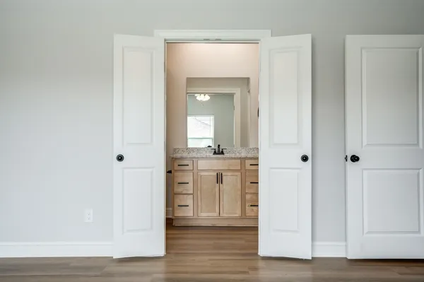 a view of a hallway with wooden floor