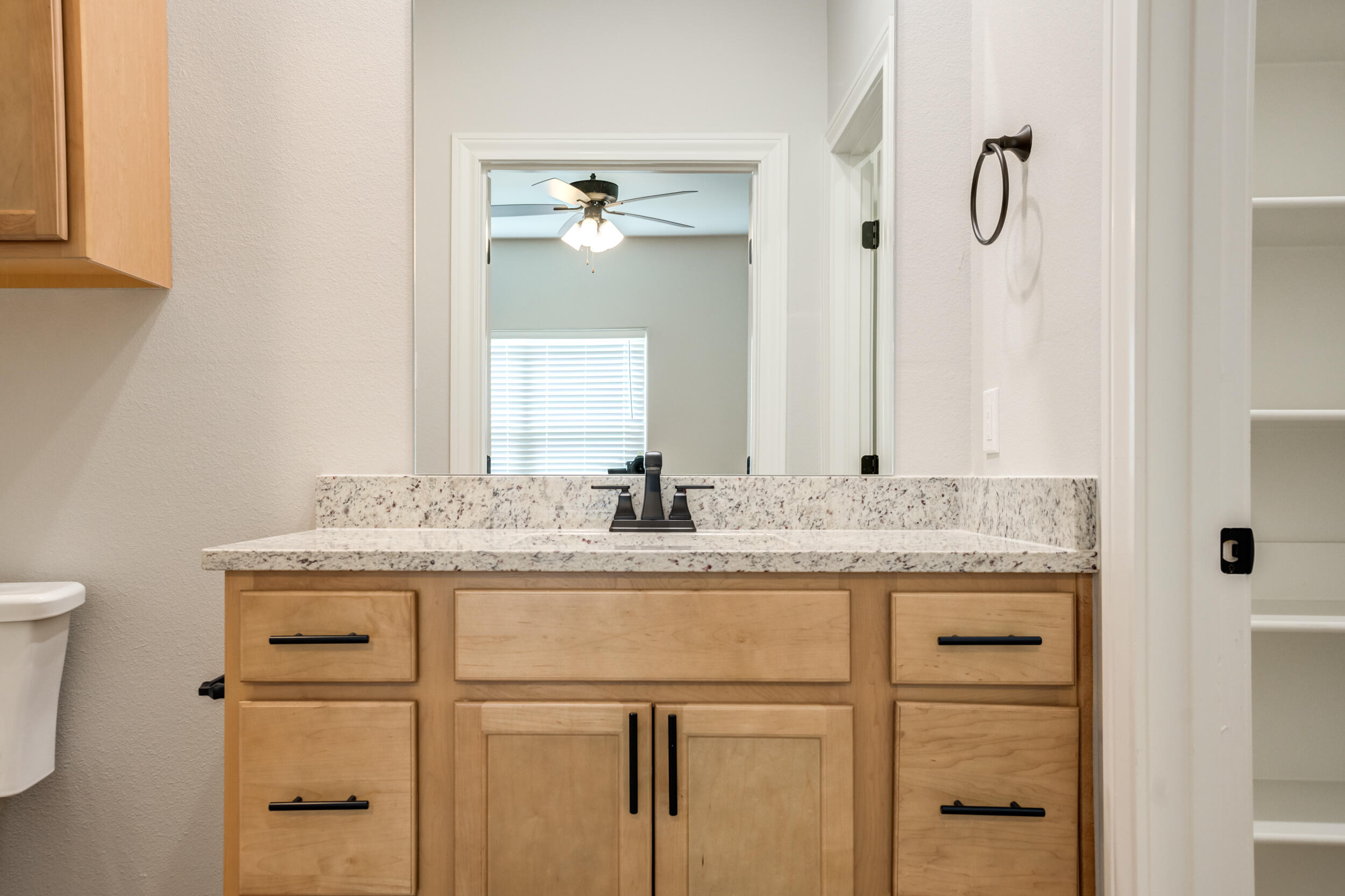 2534 137th Street Lubbock, TX 79423 - Photo 37 of 46 a bathroom with a granite countertop sink and a mirror
