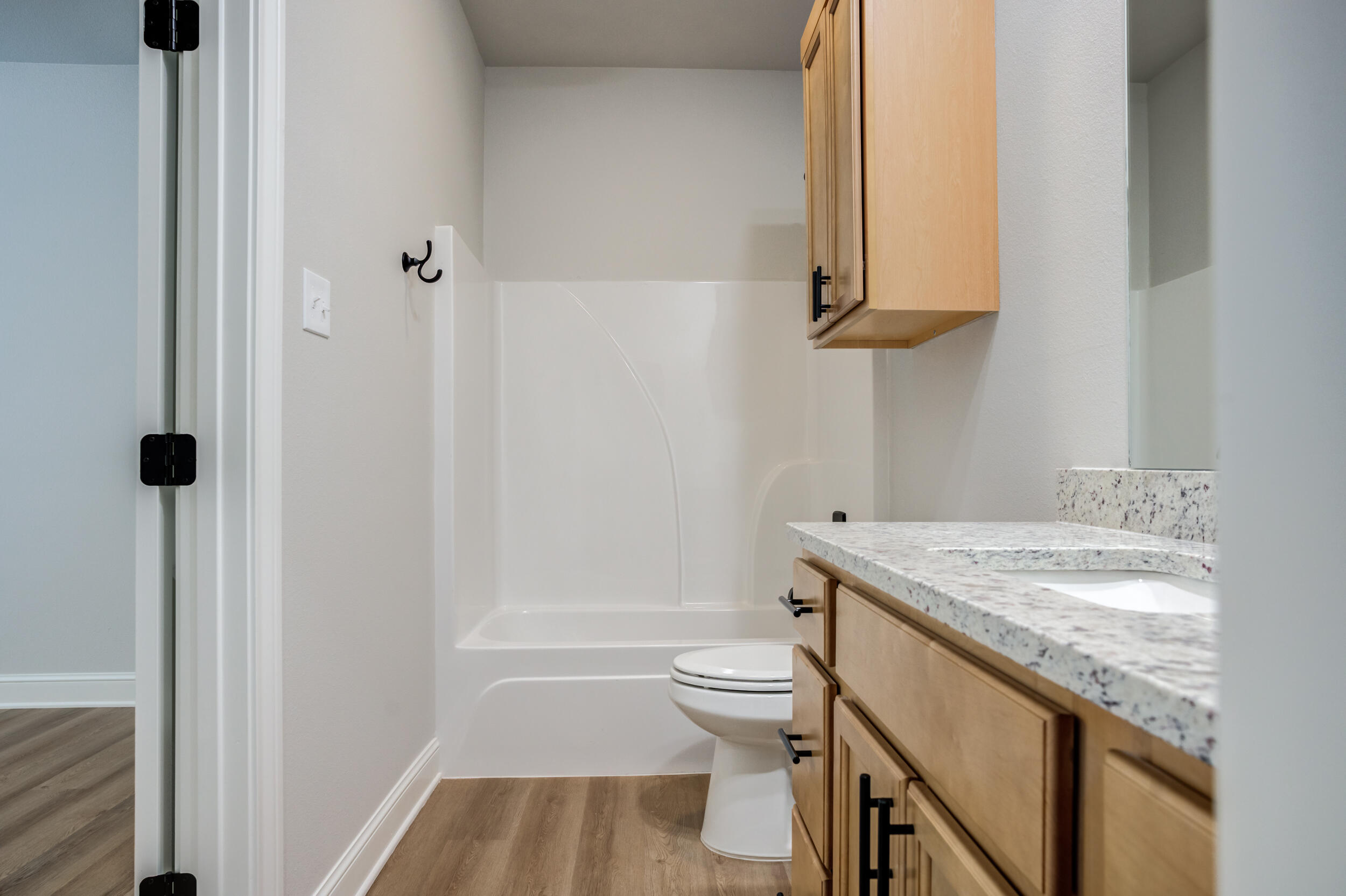 2534 137th Street Lubbock, TX 79423 - Photo 40 of 46 a bathroom with a granite countertop sink toilet and shower