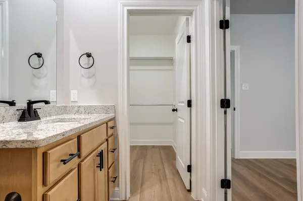 a bathroom with a granite countertop sink and a mirror
