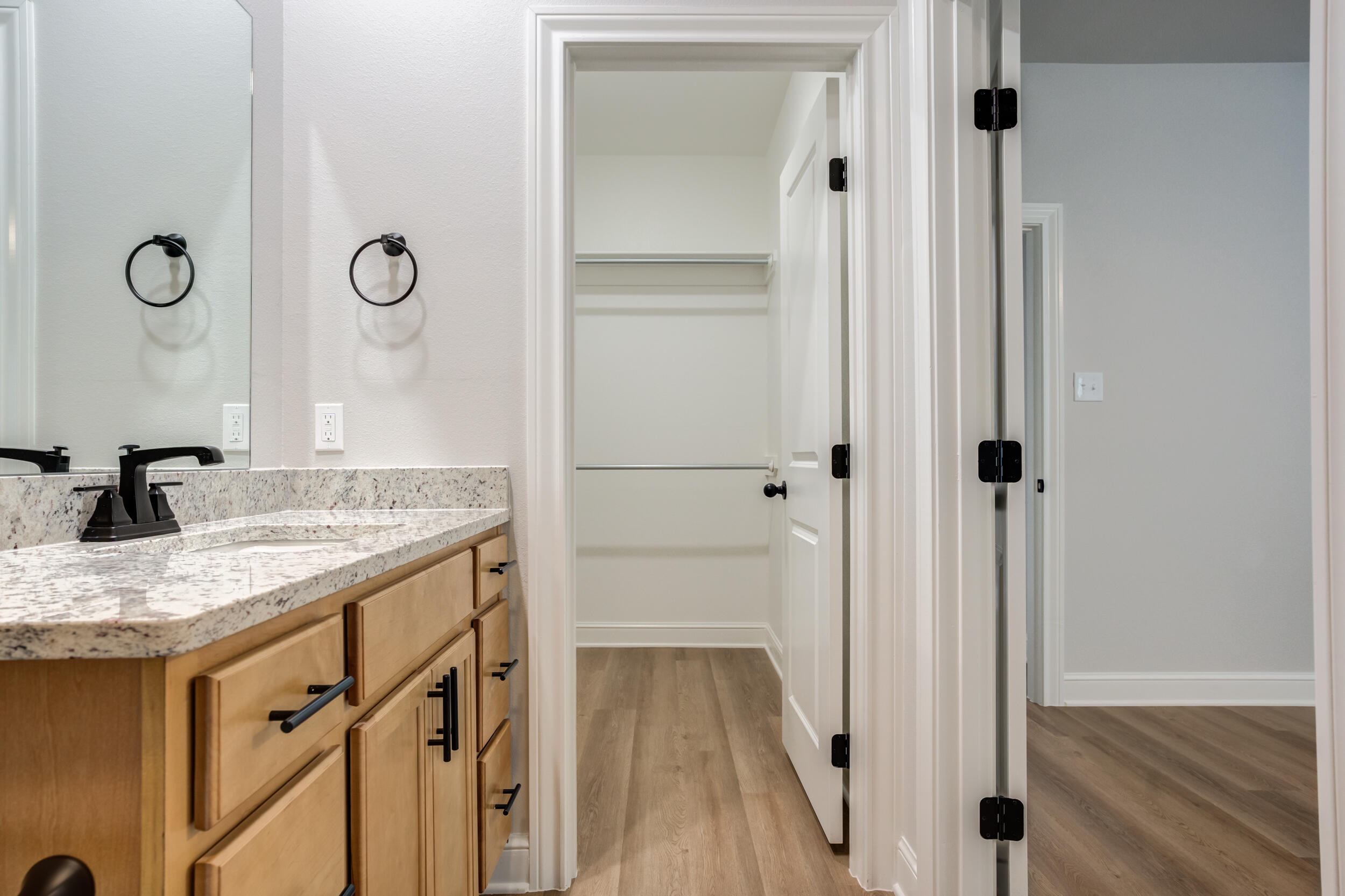 2534 137th Street Lubbock, TX 79423 - Photo 43 of 46 a bathroom with a granite countertop sink and a mirror