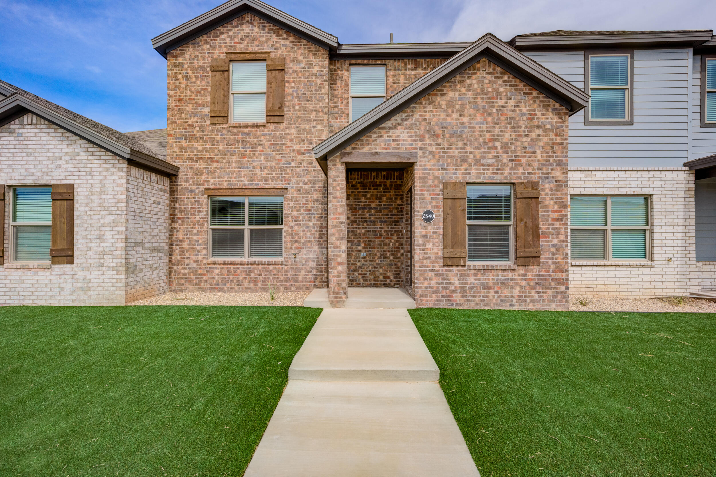 2534 137th Street Lubbock, TX 79423 - Photo 10 of 46 a front view of a house with a yard and garage