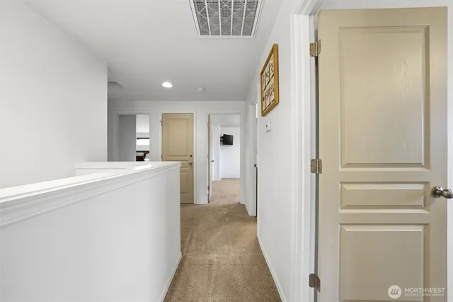 a view of a hallway with wooden shelves