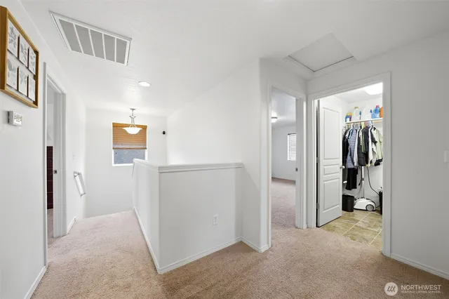 a view of a hallway with a livingroom and a livingroom with furniture