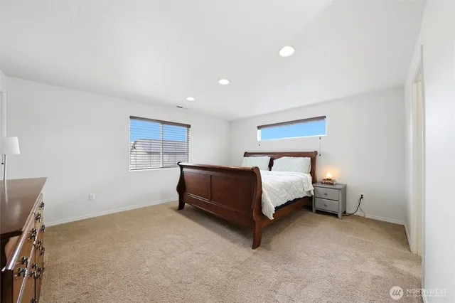 a spacious bedroom with a bed and a cabinets