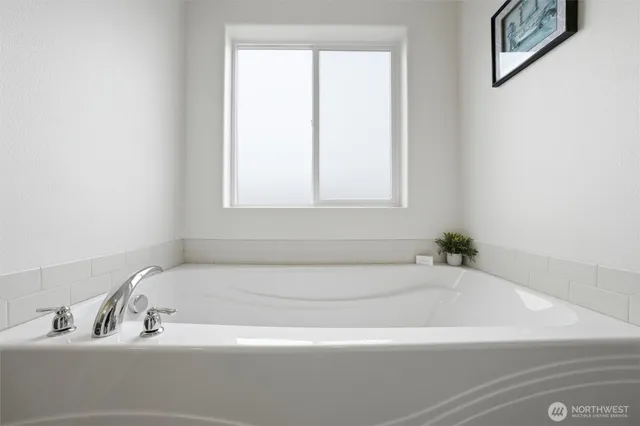 a white bath tub sitting next to a window