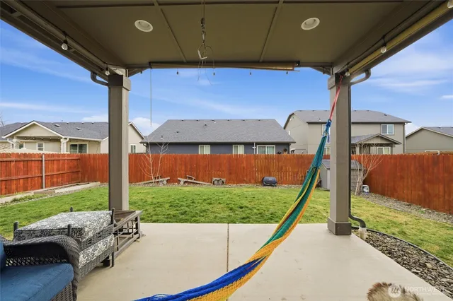 a view of a backyard with sitting area