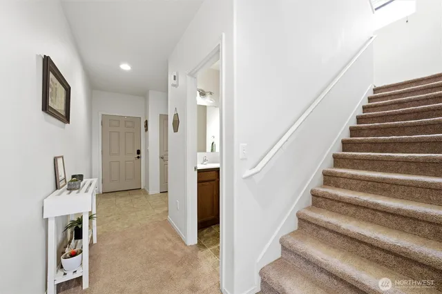 a view of entryway and hall with wooden floor