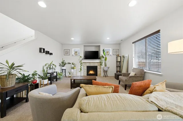 a living room with furniture potted plant and a fireplace