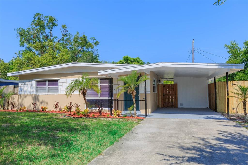 4917 Azalea Drive New Port Richey, FL 34652 - Photo 1 of 1 a front view of a house with garden