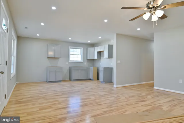 a view of a kitchen with wooden floor and electronic appliances