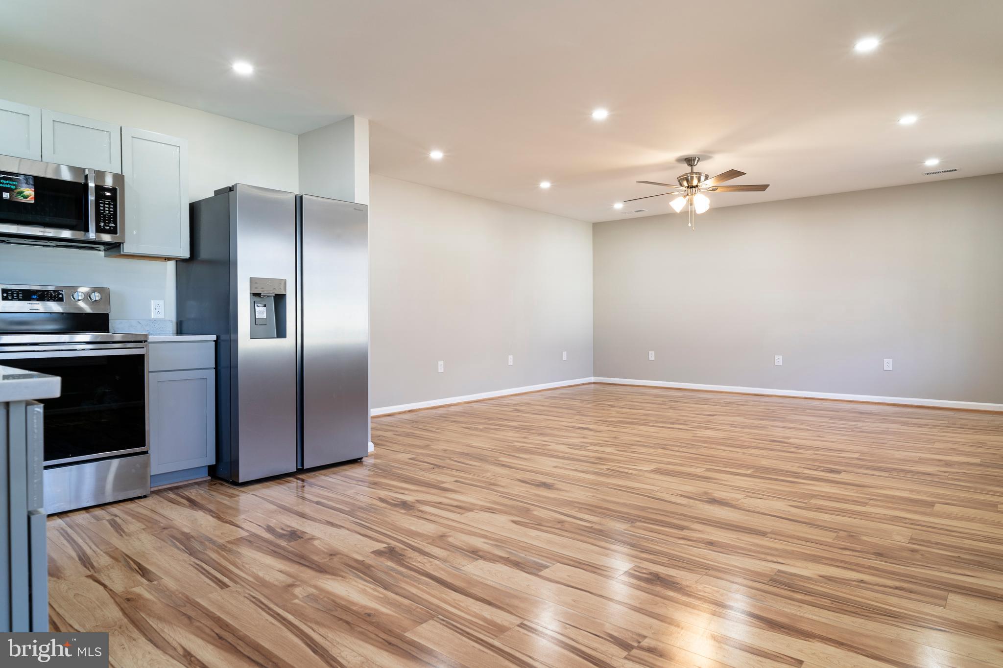 240 Deford Avenue Stanley, VA 22851 - Photo 16 of 60 an empty room with wooden floor and stainless steel appliances