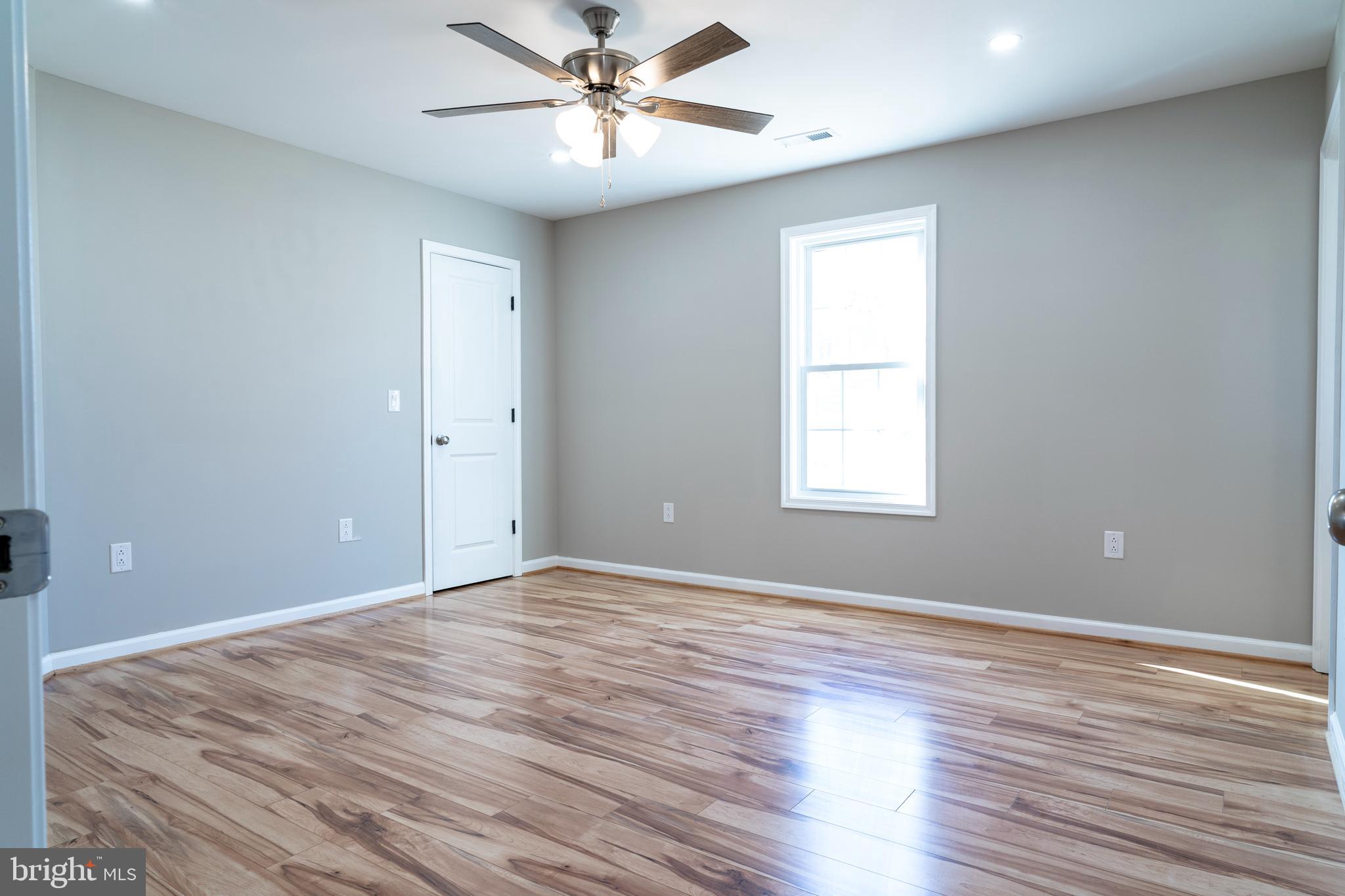 240 Deford Avenue Stanley, VA 22851 - Photo 32 of 60 a view of an empty room with wooden floor and a window