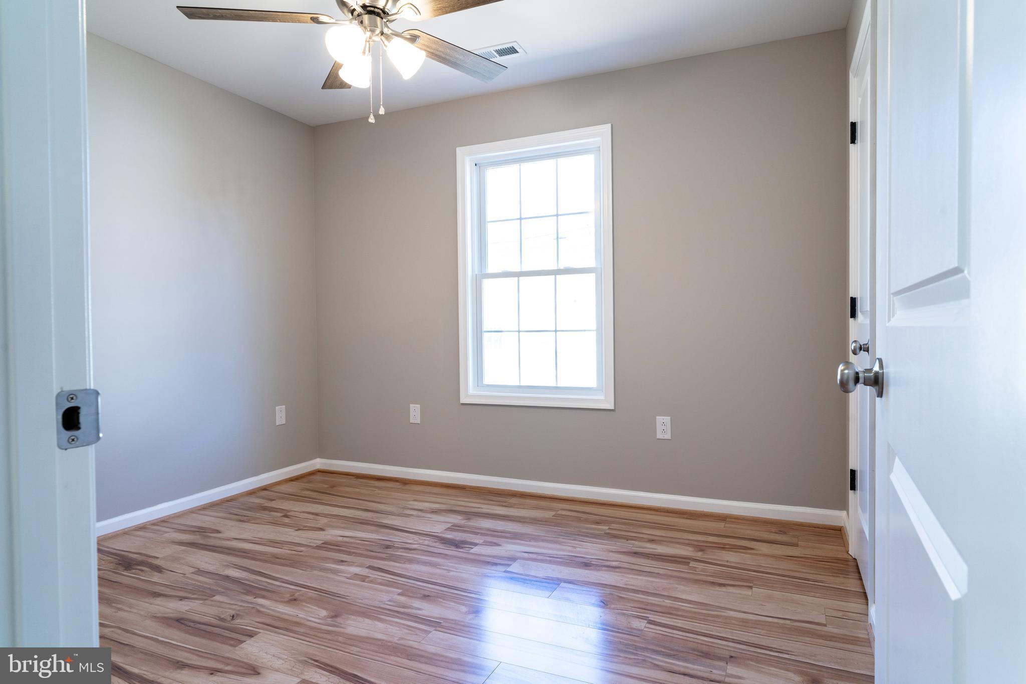 240 Deford Avenue Stanley, VA 22851 - Photo 37 of 60 wooden floor in an empty room with a window