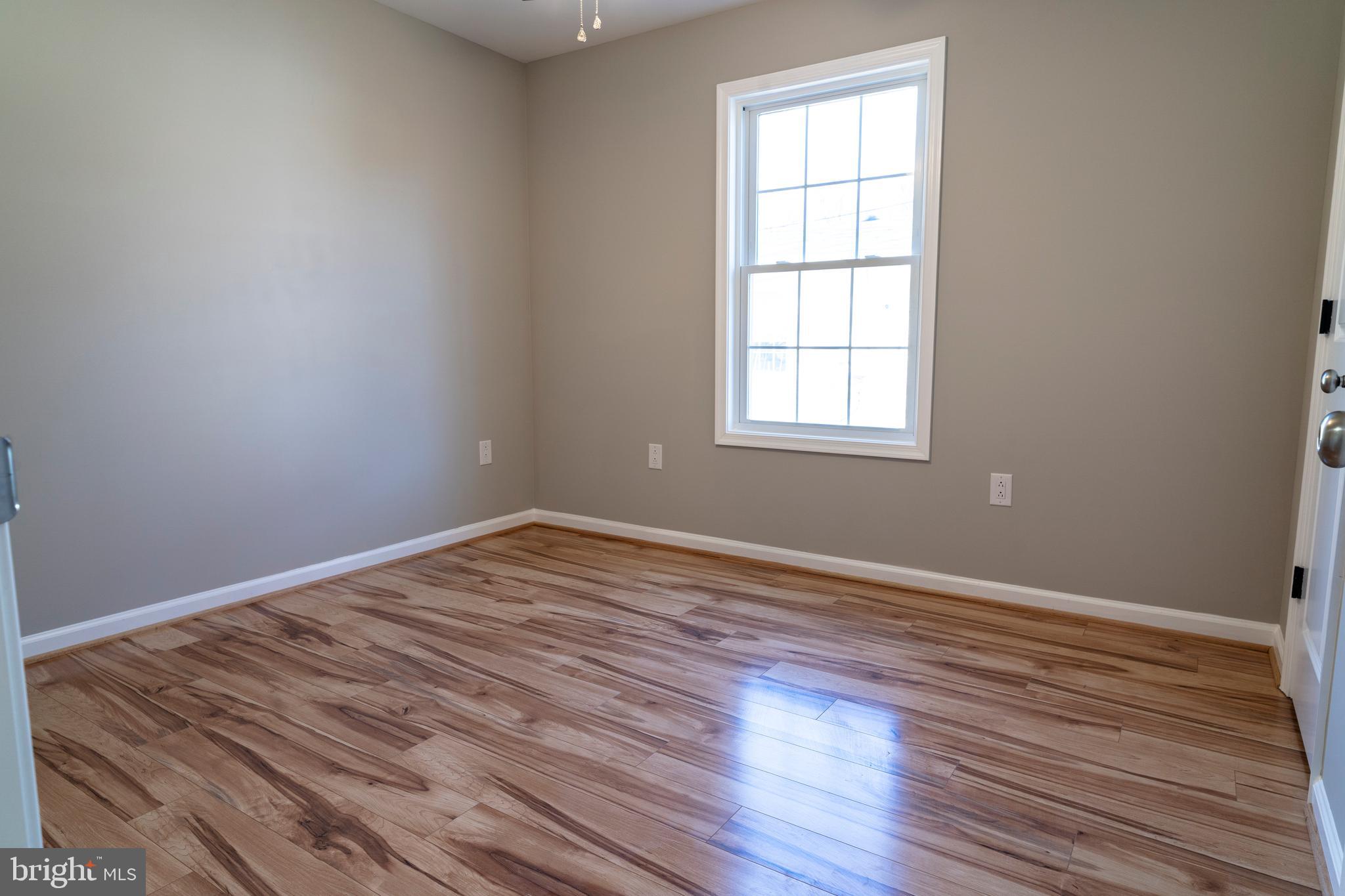 240 Deford Avenue Stanley, VA 22851 - Photo 38 of 60 an empty room with wooden floor and windows