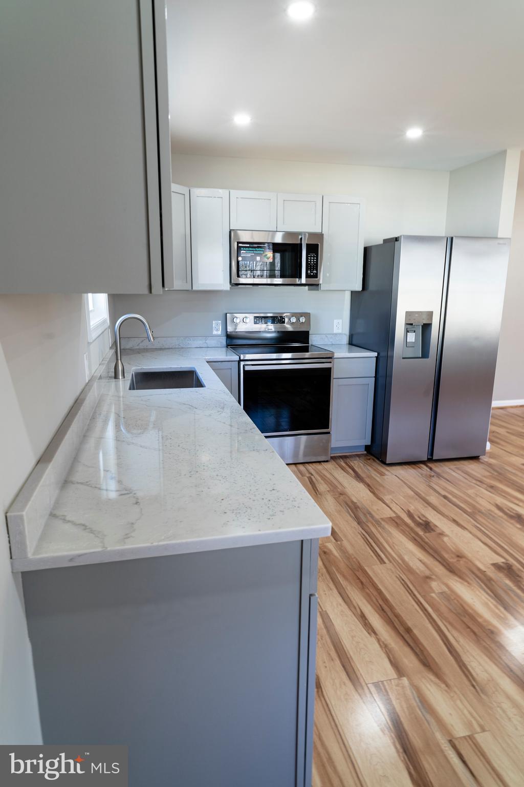 240 Deford Avenue Stanley, VA 22851 - Photo 8 of 60 a kitchen with stainless steel appliances granite countertop a sink refrigerator and microwave