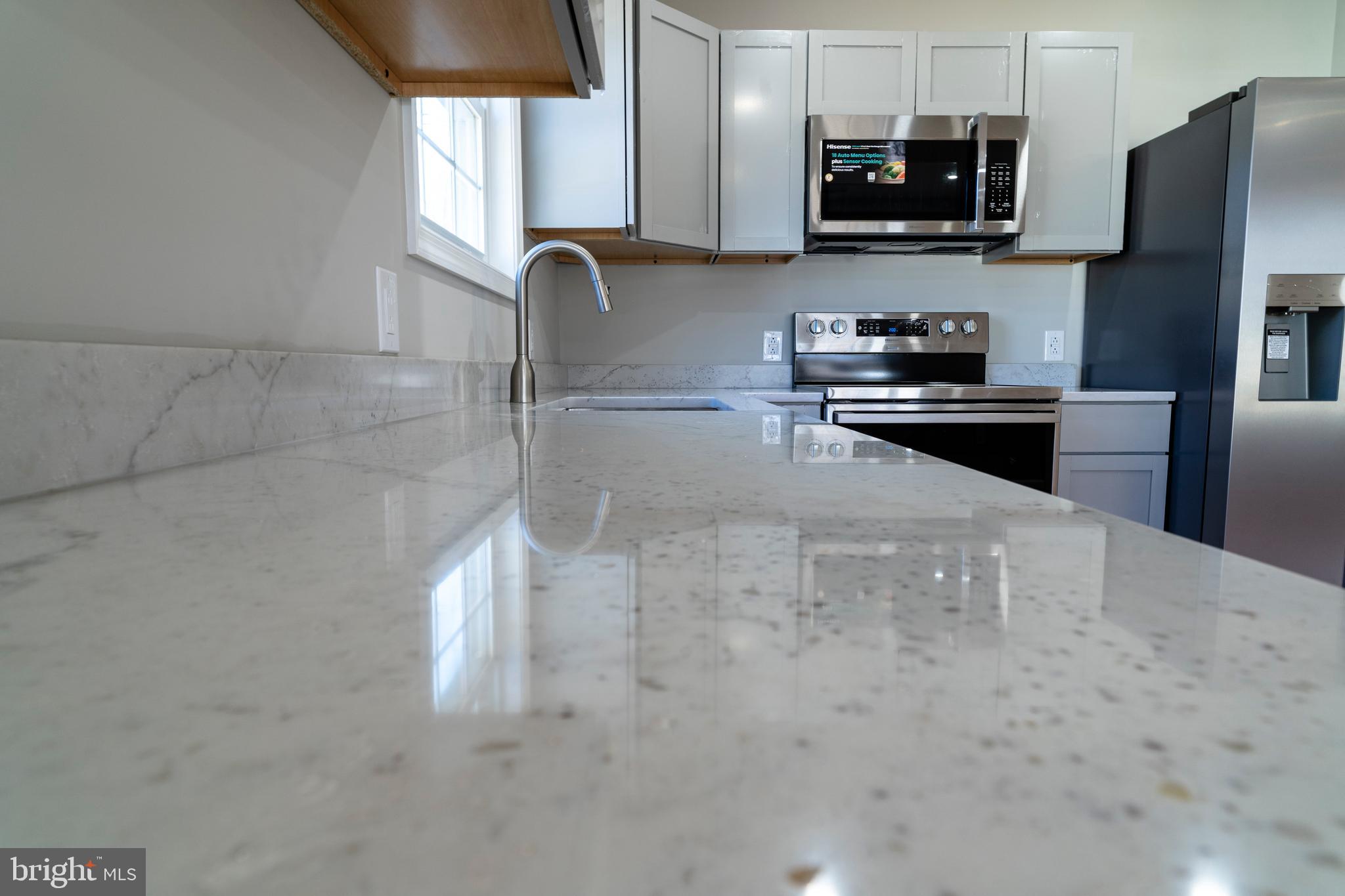 240 Deford Avenue Stanley, VA 22851 - Photo 9 of 60 a kitchen with stainless steel appliances a microwave a sink and cabinets