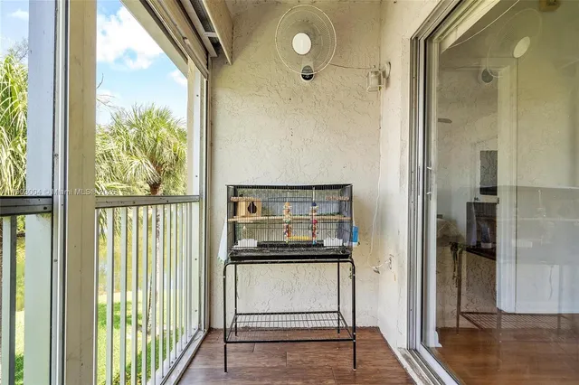 a view of a utility room with a floor to ceiling window and wooden floor