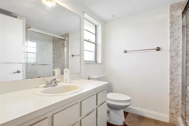 a bathroom with a sink toilet and vanity