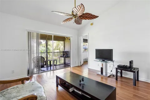 a view of a livingroom with furniture and a flat screen tv