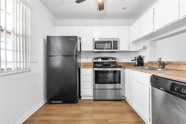 a kitchen with stainless steel appliances a refrigerator stove and microwave
