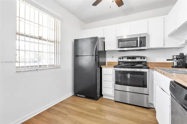a kitchen with stainless steel appliances a refrigerator stove and microwave