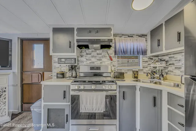 a kitchen with cabinets appliances and a counter space