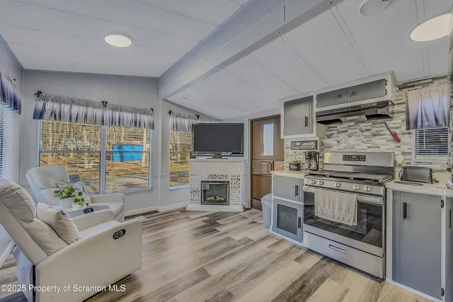 a kitchen with stainless steel appliances granite countertop a stove and cabinets