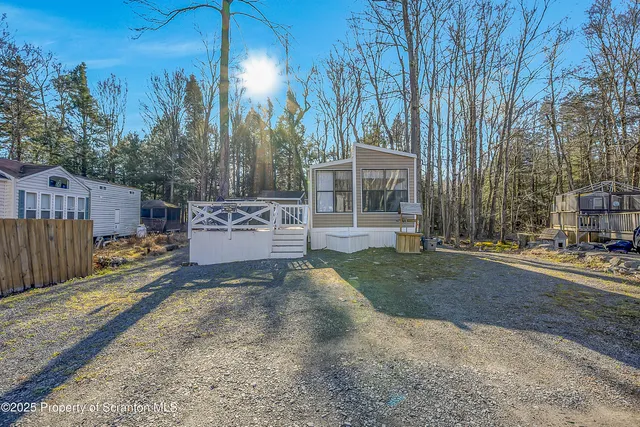 a view of a house with a yard and tree s