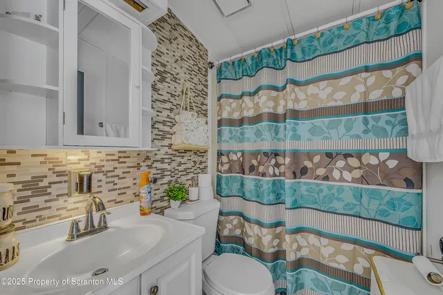 a bathroom with a sink toilet and mirror