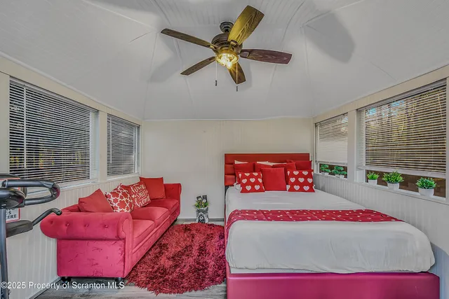 a bed room with a bed window and a couch