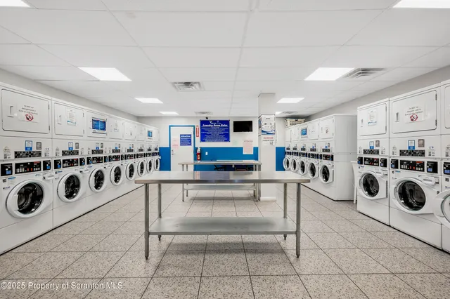 a kitchen with stainless steel appliances a stove a sink and cabinets