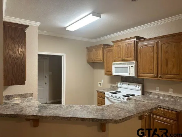 a kitchen with stainless steel appliances granite countertop a sink stove and cabinets