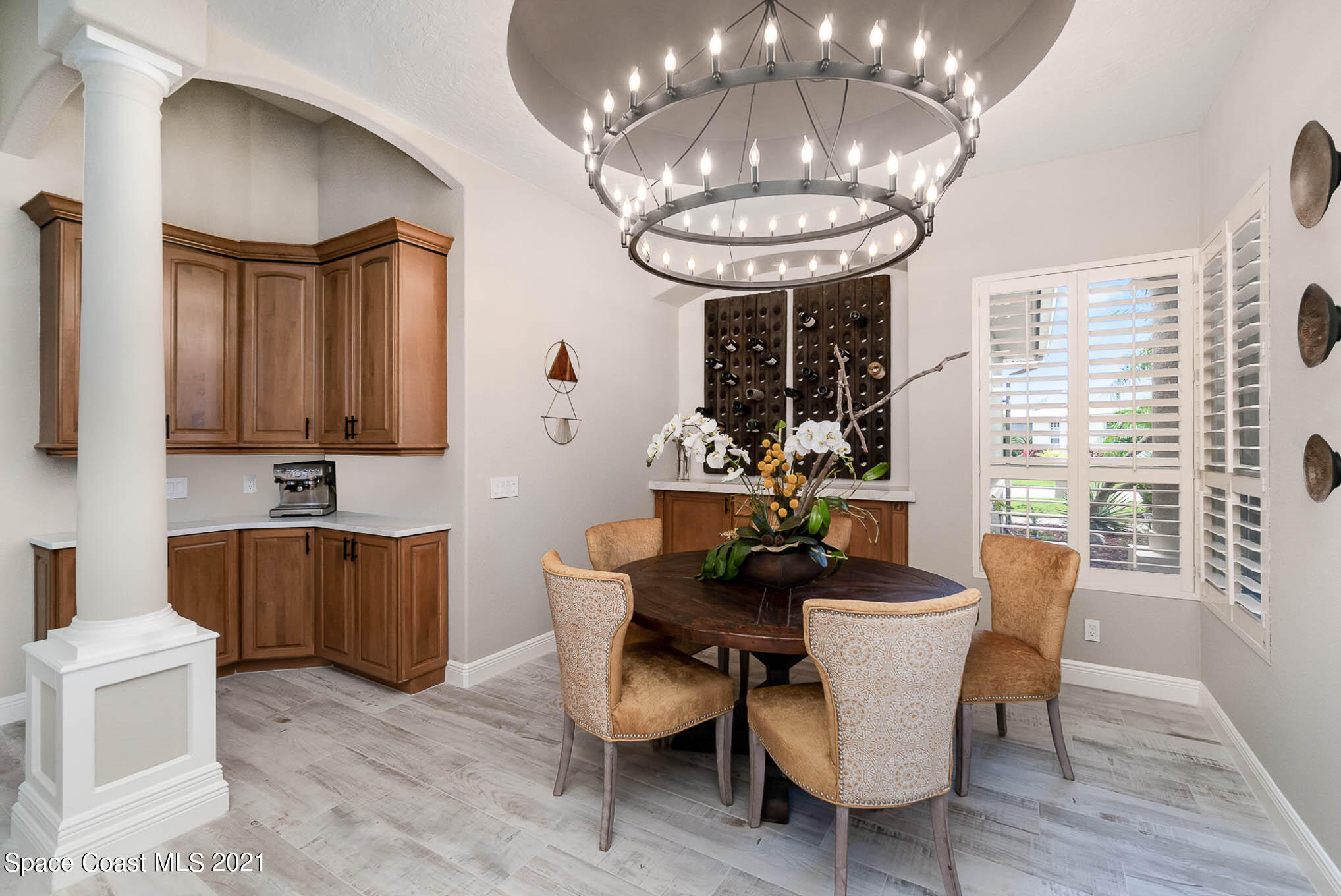 4150 Stoney Point Road Melbourne, FL 32940 - Photo 14 of 40 a view of a dining room with furniture a chandelier and wooden floor