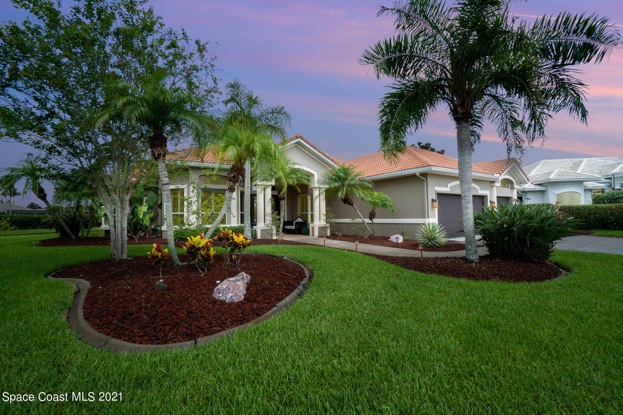 4150 Stoney Point Road Melbourne, FL 32940 - Photo 3 of 40 a view of a house with a swimming pool and a patio