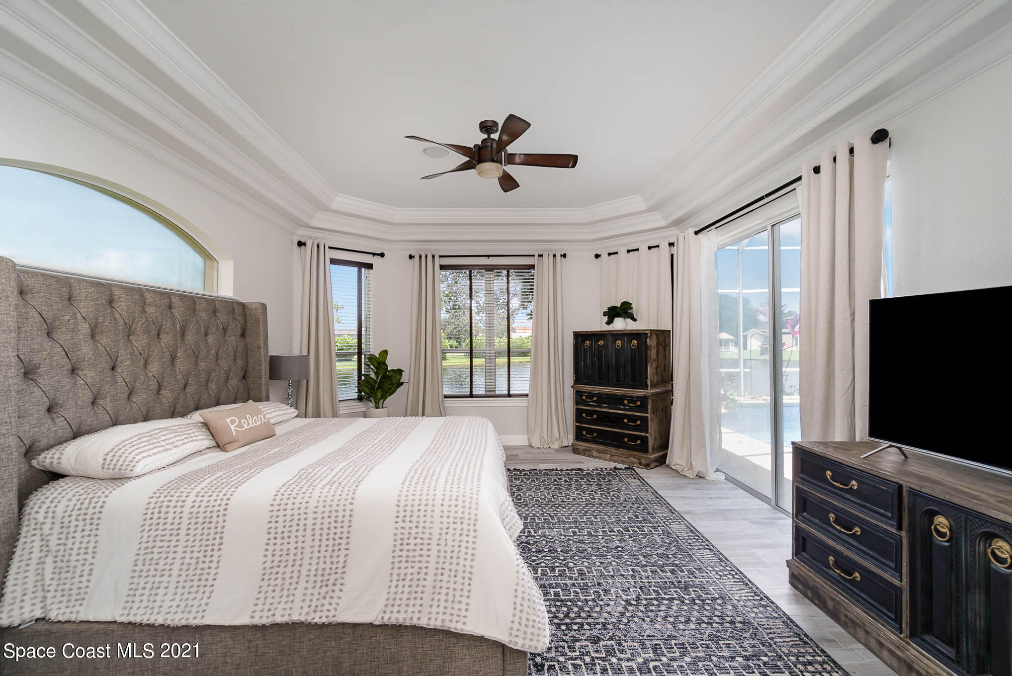 4150 Stoney Point Road Melbourne, FL 32940 - Photo 22 of 40 a bedroom with a bed and a flat screen tv