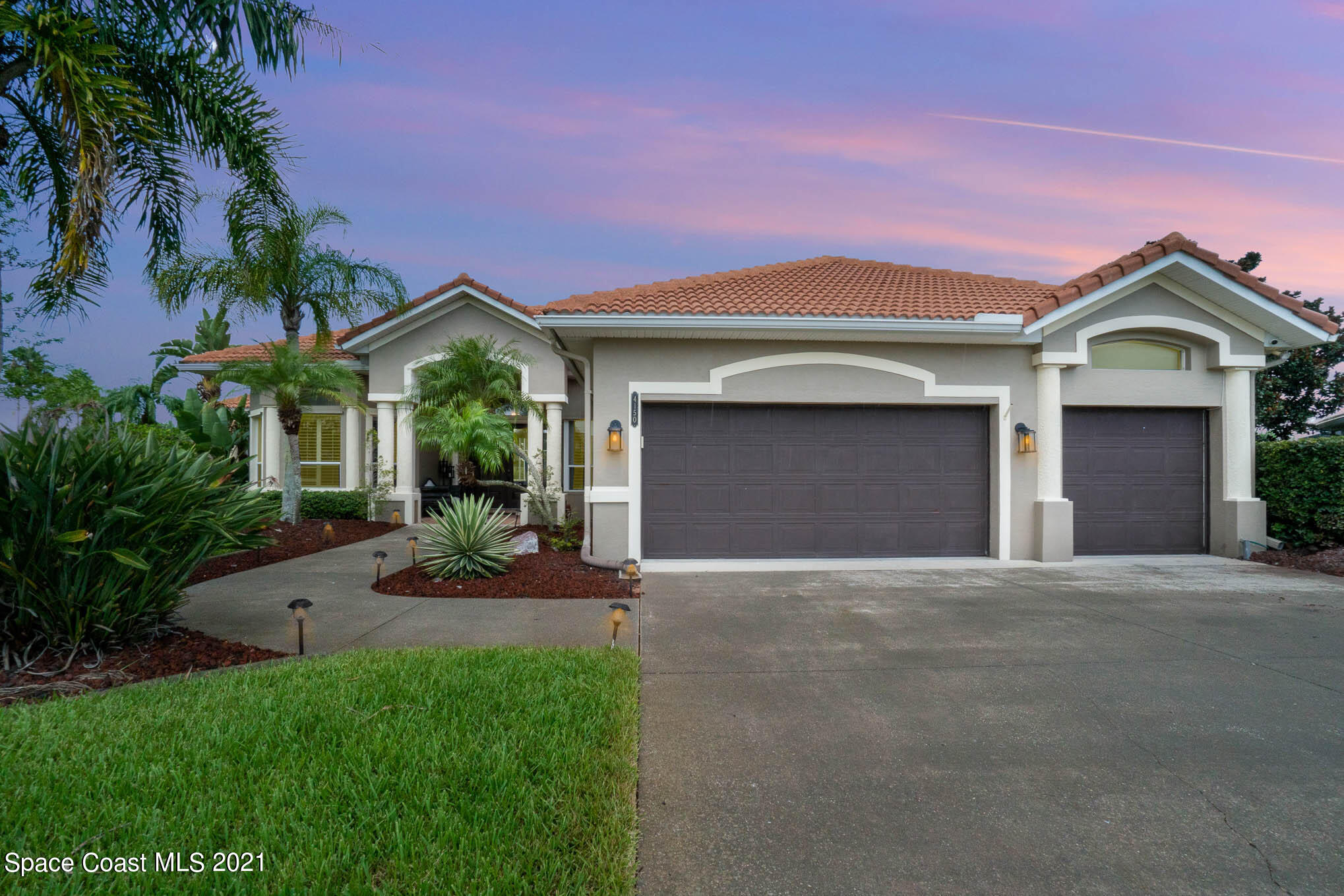 4150 Stoney Point Road Melbourne, FL 32940 - Photo 40 of 40 a front view of a house with a yard and garage