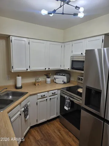 a kitchen with a sink stove and cabinets