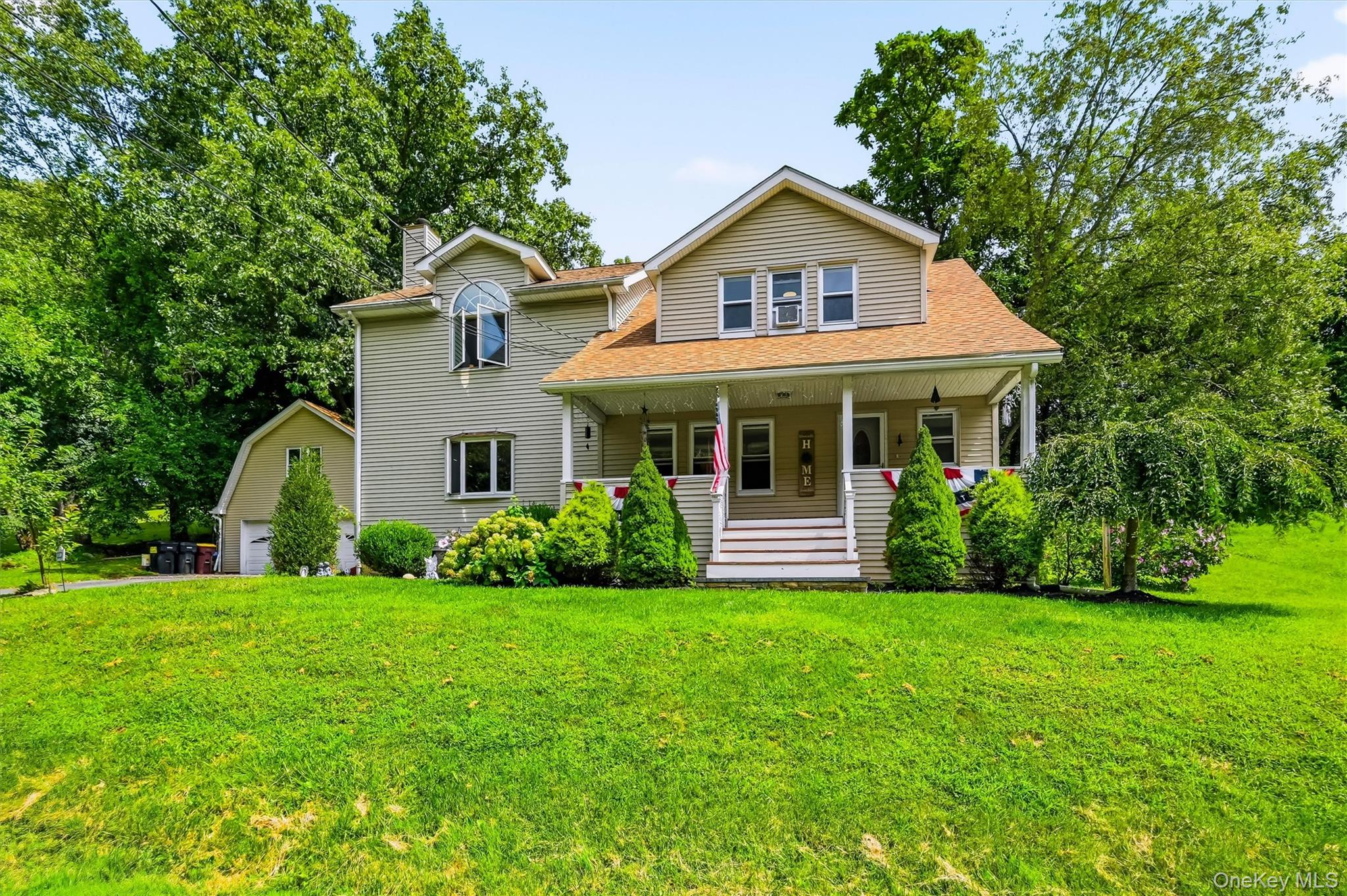 328 Big Island Road Florida, NY 10921 - Photo 37 of 40 Front exterior featuring a covered porch, spacious lawn and detached garage.