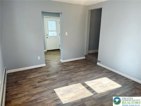 an empty room with wooden floor