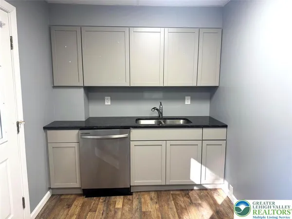 a kitchen with white cabinets