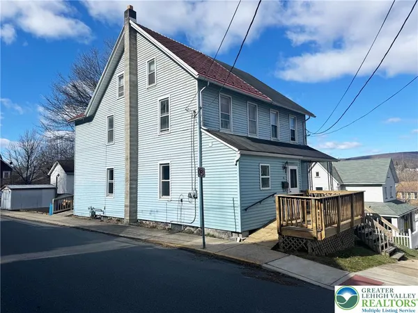 a view of a house with wooden deck