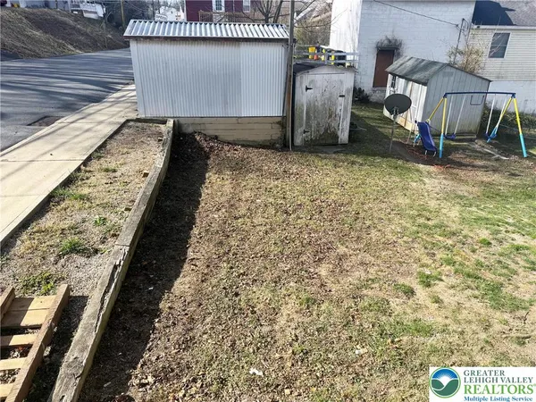 a view of a backyard of the house