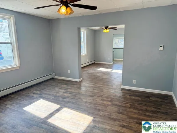 wooden floor in an empty room with a window