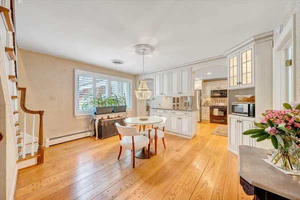 a kitchen with granite countertop a sink stove and cabinets