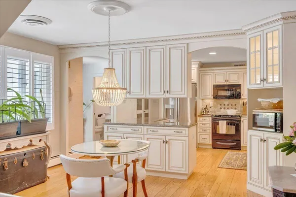 a kitchen with granite countertop a refrigerator stove and sink