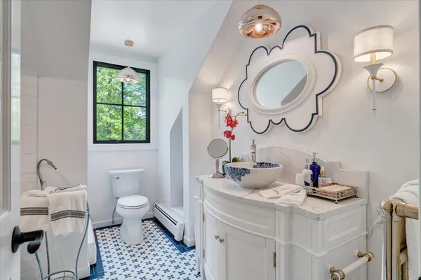 a bathroom with a toilet a sink and shower
