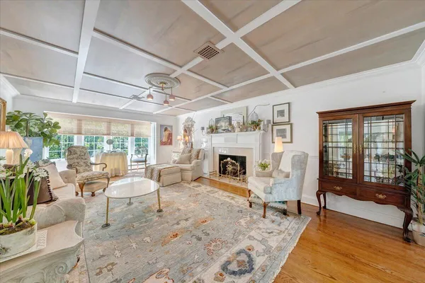 a living room with furniture and floor to ceiling windows