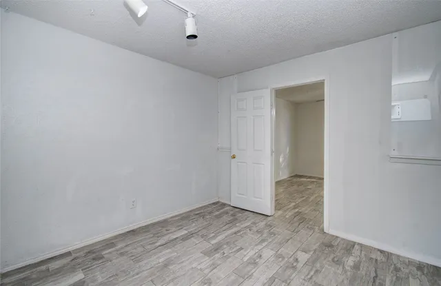 a view of a room with wooden floor